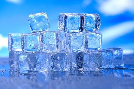 Ice cubes on blue background