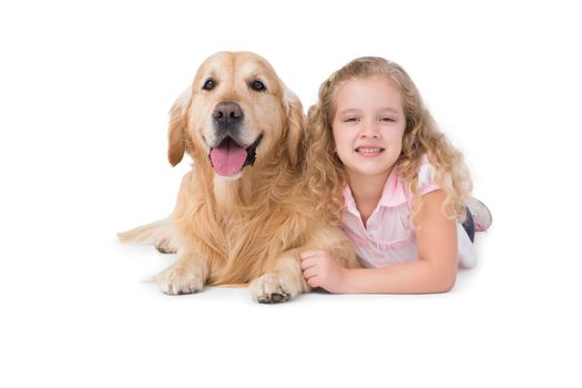 Little girl and dog lying on the floor on white background