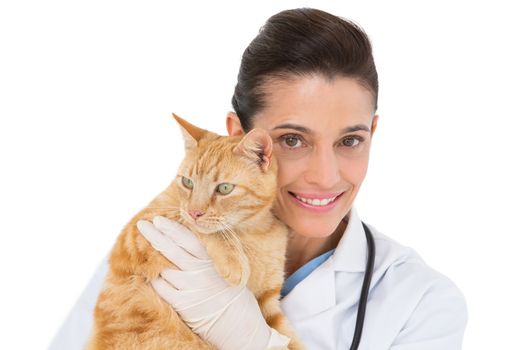 Smiling vet with a cat in her arms on white background
