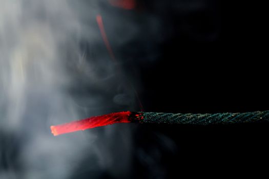 Burning fuse of a firecracker.