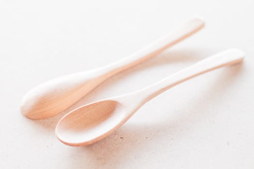 Empty spoons on wooden background, stock photo