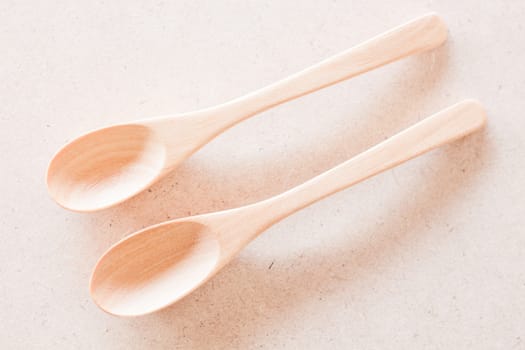 Top view of wooden spoons on brown background, stock photo
