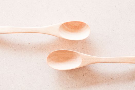 New wooden spoons on brown background, stock photo