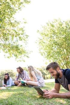 Classmates revising together on campus on a summers day