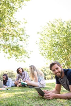 Classmates revising together on campus on a summers day