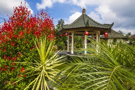 Azian Gazebo under Blue Sly and Beautiful Flowers