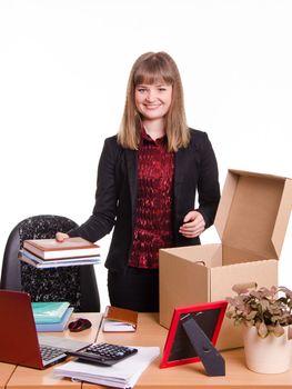 The girl accepted a job at the office and arranges personal belongings at the new workplace