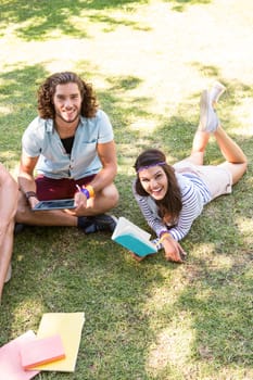 Classmates revising together on campus on a summers day