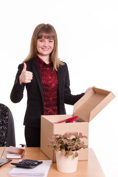 The girl accepted a job at the office and arranges personal belongings at the new workplace
