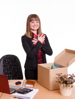 The girl accepted a job at the office and arranges personal belongings at the new workplace