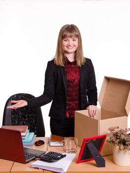 The girl accepted a job at the office and arranges personal belongings at the new workplace