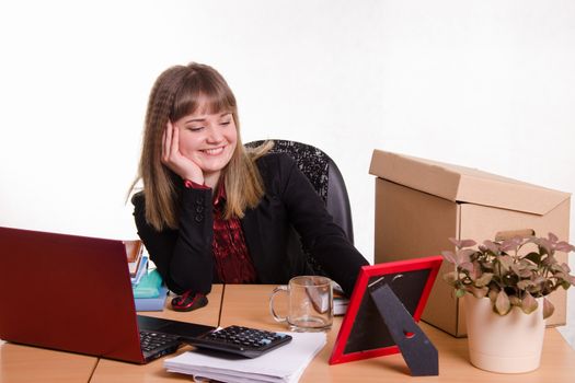 Cute business woman in the office at the computer