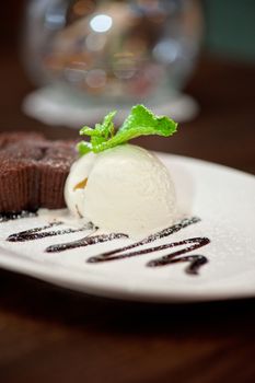 chocolate cake with ice cream at white plate