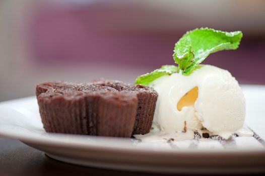 chocolate cake with ice cream at white plate