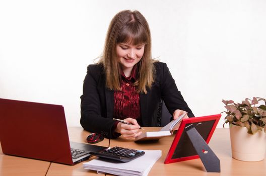 Cute business woman in the office at the computer