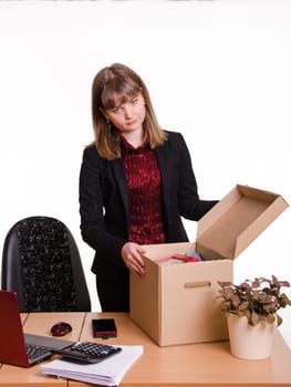 Woman fired from her job at the office and collect personal belongings in a box
