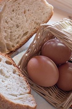 photograph depicting eggs in the basket and sliced bread