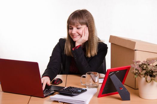 Cute business woman in the office at the computer