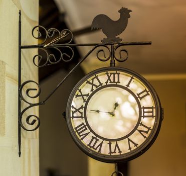 Photo of a Vintage Outdoor Chime with a Bell Hanging.