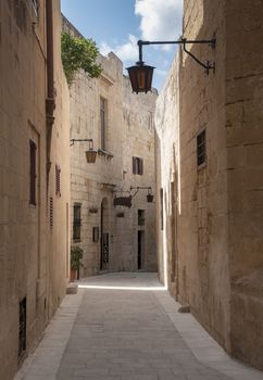 old street with ligths and amber building on the island malta