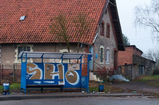 Old house. Kaliningrad region. Russia. Graffiti at the bus stop.