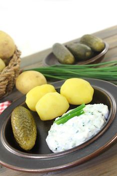 Herb curd with boiled potatoes and pickled cucumber