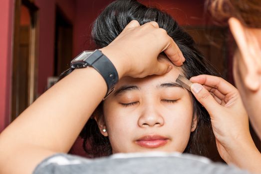 Asian Thai Girl Getting Eyebrow Shaped.