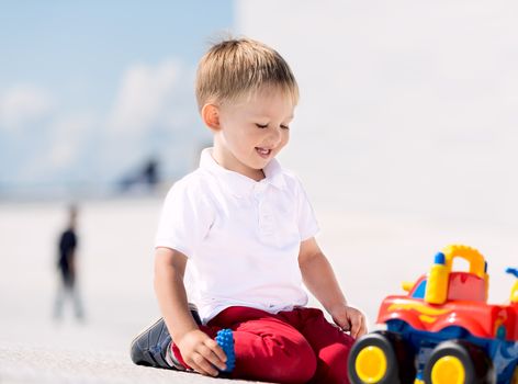 Little boy playing with toy car