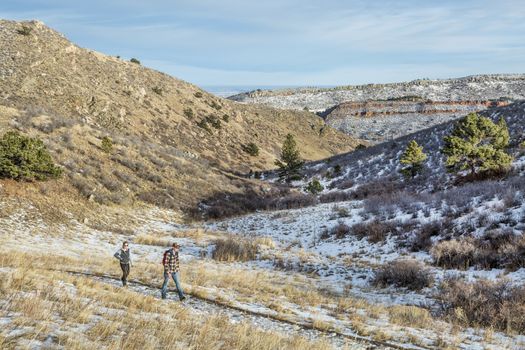 FORT COLLINS, CO, USA - January 6, 2015:  A young couple hiking in Horsetooth Mountain Park, a popular recreation area near Fort Collins in northern Colorado