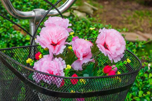 Pink Plastic Flower in Bicycle Basket.