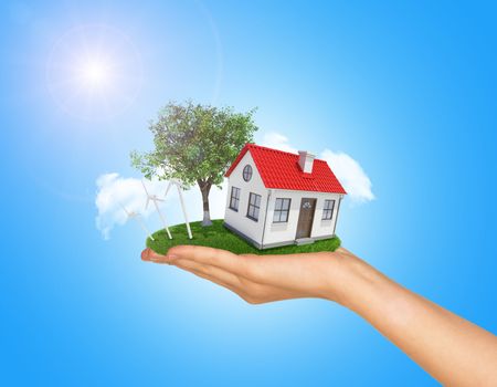 White shack in hand with red roof, brown door and chimney. Background sun shines brightly on left. Blue sky