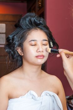 Asian Thai Girl Getting Makeup Foundation.