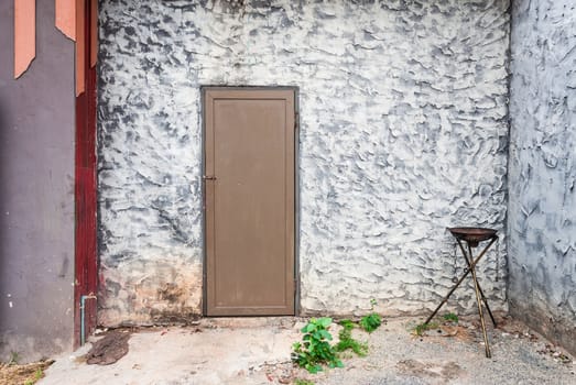 Rough Concrete Wall with Wood Door and Fire Torch Stand.