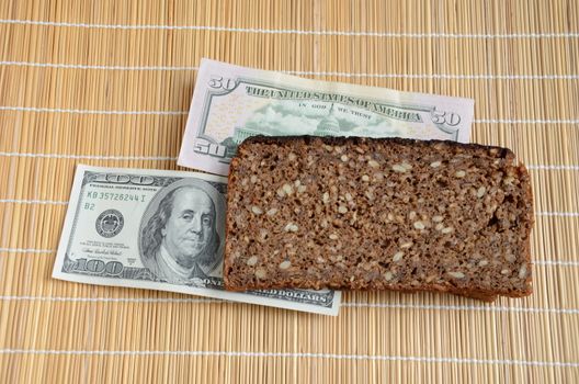 slice of brown bread with US dollar bills on table