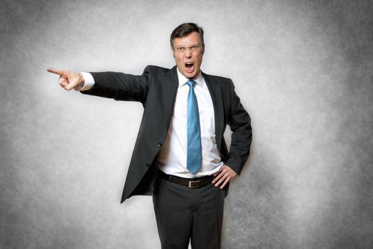 image of angry business man in suit who is screaming and pointing with finger