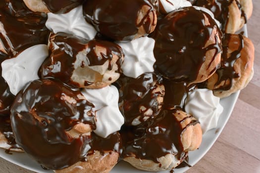 Cream puffs filled with cream covered with chocolate