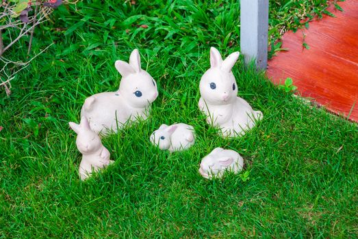 Cement Rabbit Figures on Grass.