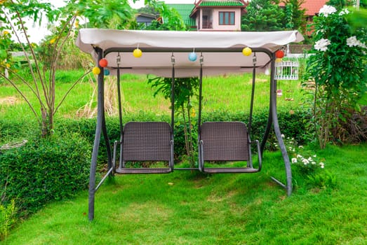 Metal Rattan Swing in Garden.