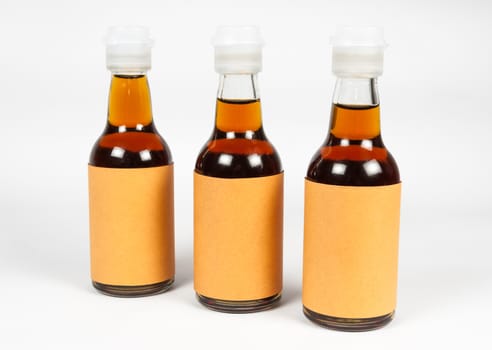 Glass Bottles with Liquid, Blank Label and Plastic Cap.