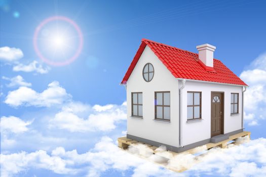 White house with red roof, brown door and chimney in clouds. Background sun shines brightly. Blue sky