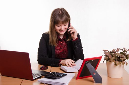 Cute business woman in the office at the computer