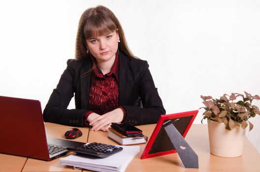 Cute business woman in the office at the computer