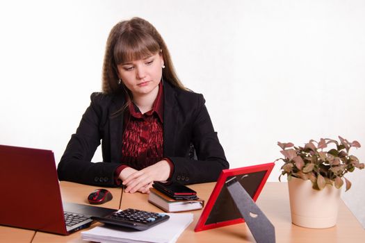 Cute business woman in the office at the computer