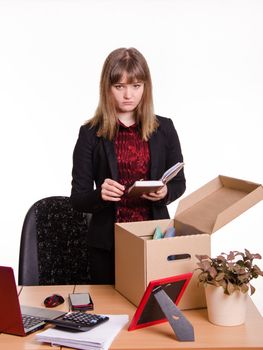 Woman fired from her job at the office and collect personal belongings in a box with a sad view