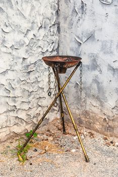 Empty Rusty Steel Fire Torch on Brass Stand.