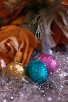 composition of three chocolate eggs colored neighbors