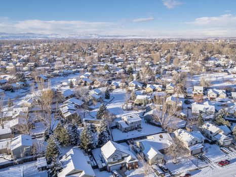 FORT COLLINS, CO, USA - December 28 2014: Aerial view of typical residential neighborhood along Front Range of Rocky Mountains in Colorado, winter scenery shot from a low flying drone