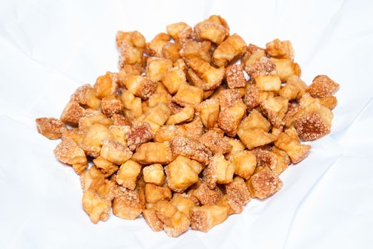 Deep Fried Pork Skin on White Paper [Soft Focus].