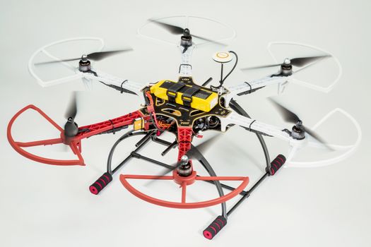 FORT COLLINS, CO, USA, December 13,  2014:  Radio controlled DJI  F550 Flame Wheel  hexacopter drone with spinning rotors on a white background. This drone is assembled from  a kit,