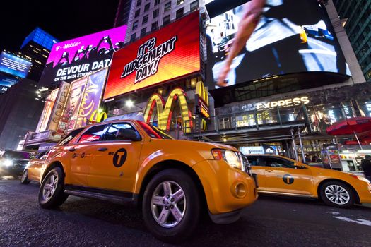 New York City, USA - October 4, 2014 : Times Square, featured with Broadway Theaters, Taxi Cabs and animated LED signs, is a symbol of New York City and the United States.